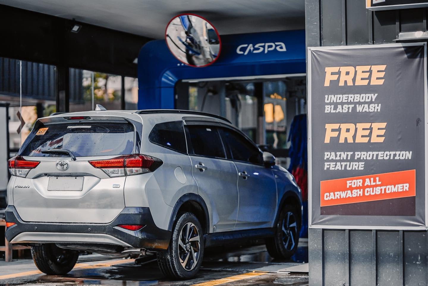 Silver SUV parked at the CASPA Xtreme entrance beside a free underbody wash banner